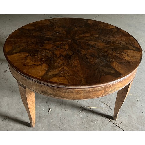 60 - A circular burr walnut dining table. 133cm d x 79cm h. The base with pull out mechanism but no extra... 