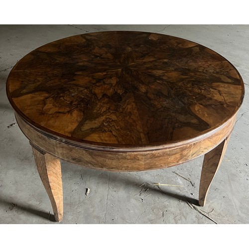 60 - A circular burr walnut dining table. 133cm d x 79cm h. The base with pull out mechanism but no extra... 