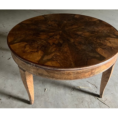 60 - A circular burr walnut dining table. 133cm d x 79cm h. The base with pull out mechanism but no extra... 