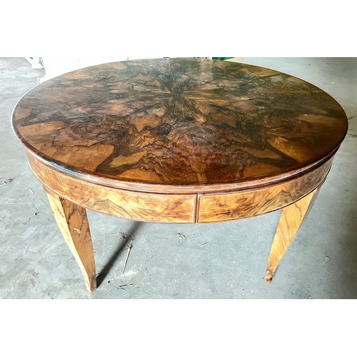 60 - A circular burr walnut dining table. 133cm d x 79cm h. The base with pull out mechanism but no extra... 