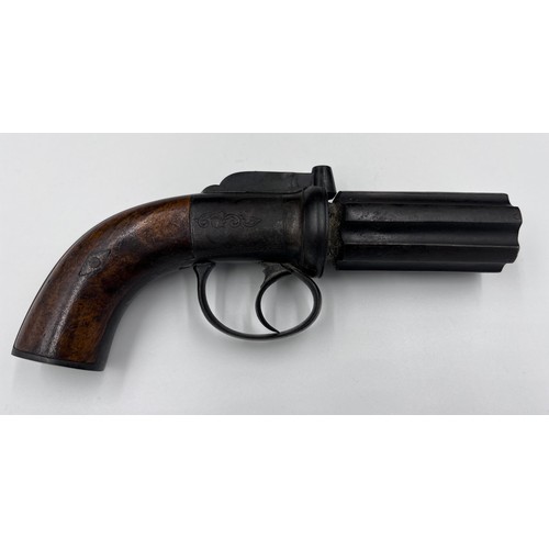 1209 - A pepper pot percussion cap six-shot pistol with walnut stock and engraved decoration.