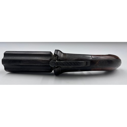 1209 - A pepper pot percussion cap six-shot pistol with walnut stock and engraved decoration.