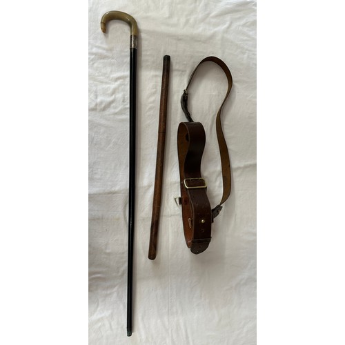 1210 - A WW1/WW2 British Sam Browne leather belt and an Officers swagger stick together with an ebony walki... 