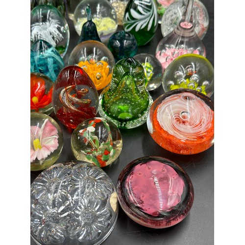 313 - A large collection of paper weights, various colours, shapes and sizes named ones to include T.V.G.,... 