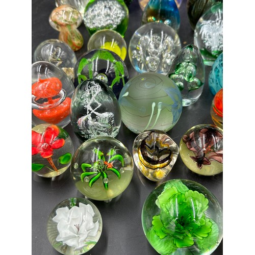 313 - A large collection of paper weights, various colours, shapes and sizes named ones to include T.V.G.,... 