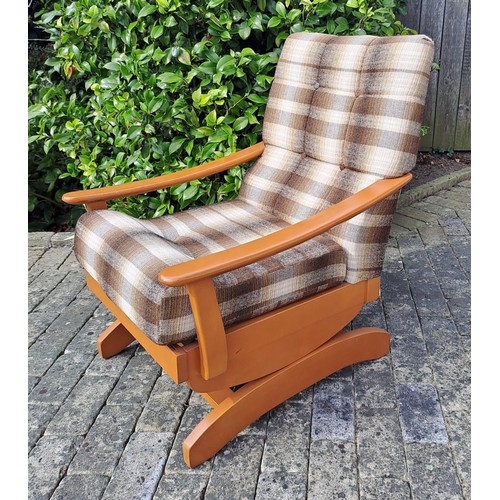 67 - A mid century upholstered rocking chair. 82cm h x 60cm w x 68cm d