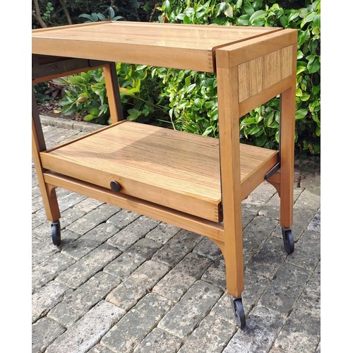 70 - A mid century tea trolley on castors and opening up to form a square topped  table. 74cm h x 78cm w ... 