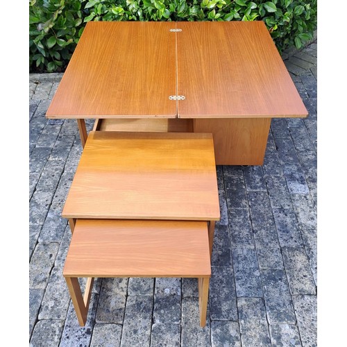 71 - A mid century coffee table with two nesting tables, and foldover top and a cupboard to one end. 56 h... 