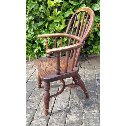 72 - A 19thC ash and elm child’s Windsor chair with crinoline stretcher. 60cm h x 35cm w x 26cm d.