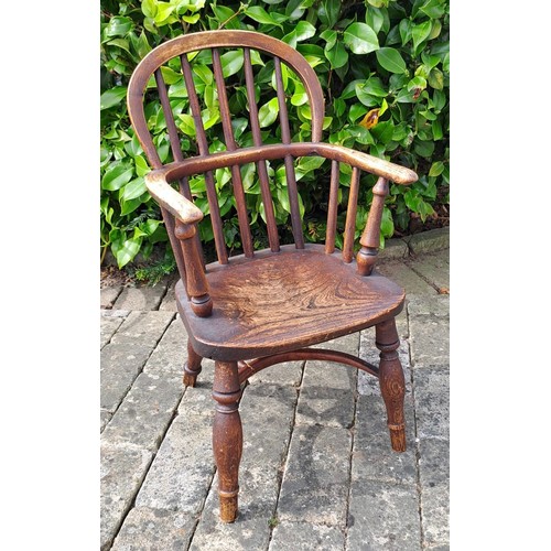 72 - A 19thC ash and elm child’s Windsor chair with crinoline stretcher. 60cm h x 35cm w x 26cm d.