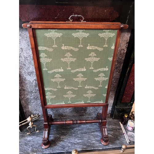 64 - A 19thC mahogany framed fabric covered fire screen with pull up top on brass castors. 60cm w x 102cm... 