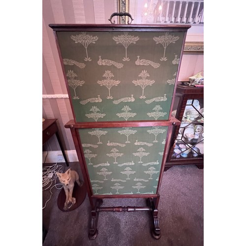 64 - A 19thC mahogany framed fabric covered fire screen with pull up top on brass castors. 60cm w x 102cm... 