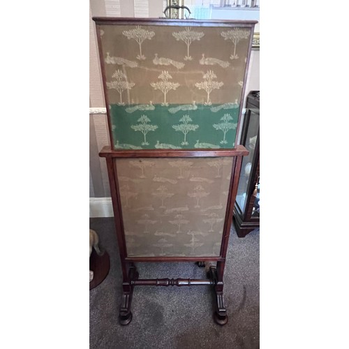 64 - A 19thC mahogany framed fabric covered fire screen with pull up top on brass castors. 60cm w x 102cm... 