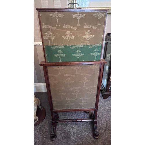 64 - A 19thC mahogany framed fabric covered fire screen with pull up top on brass castors. 60cm w x 102cm... 