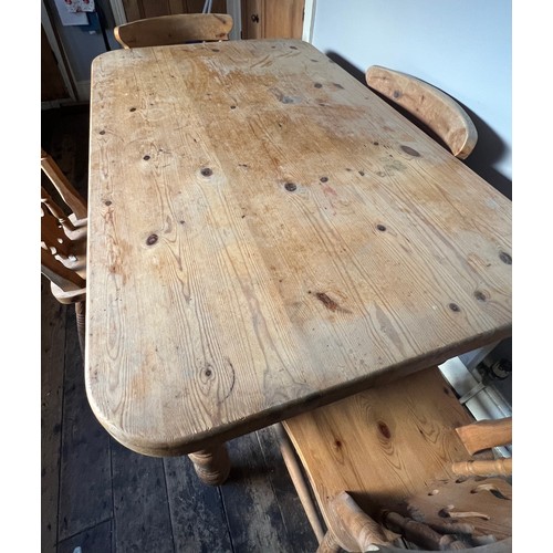 73 - A pine kitchen table with single drawer to one side together with four chairs. Table 135cm w x 81cm ... 