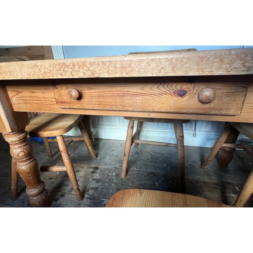 73 - A pine kitchen table with single drawer to one side together with four chairs. Table 135cm w x 81cm ... 