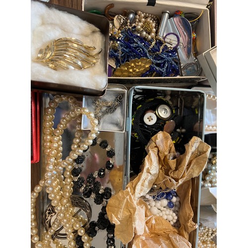 355 - A large quantity of vintage costume jewellery and boxes to include brooches, beads etc.