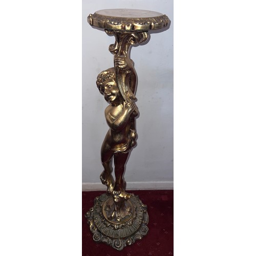 87 - A gilt torchère formed as a standing cherub. 102cm h.