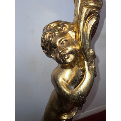 87 - A gilt torchère formed as a standing cherub. 102cm h.