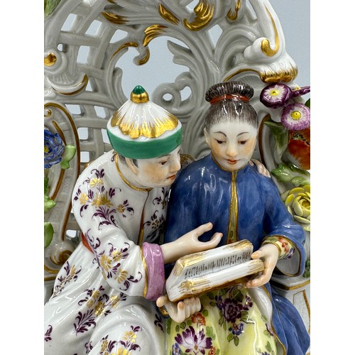 255 - A Meissen porcelain 20thC chinoiserie figure group of a Chinese couple sitting in a floral arbour wi... 