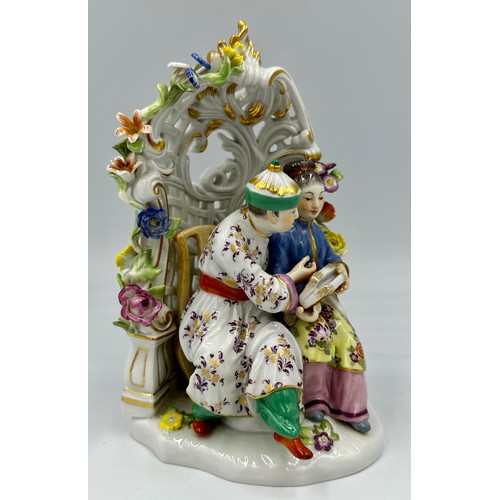 255 - A Meissen porcelain 20thC chinoiserie figure group of a Chinese couple sitting in a floral arbour wi... 