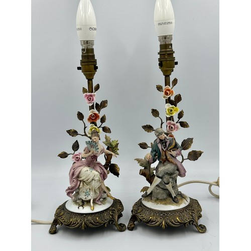 159 - A pair of Capodimonte and gilt metal figure table lamps modelled as an 18th century courting couple.... 