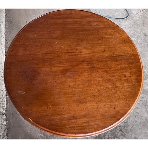 35 - A 19thC circular mahogany tilt top table on central pedestal and claw feet.