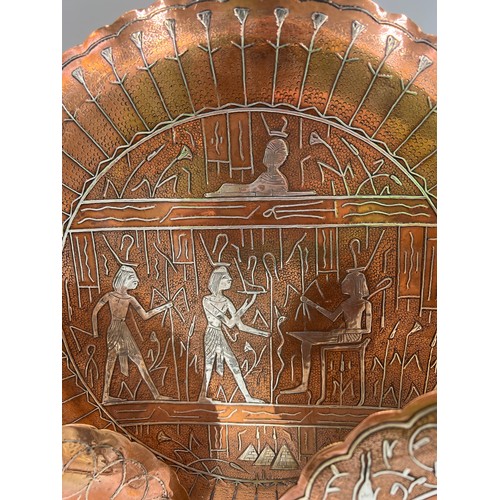 1188 - Three Egyptian copper and white metal wall plates, largest 35cm d.