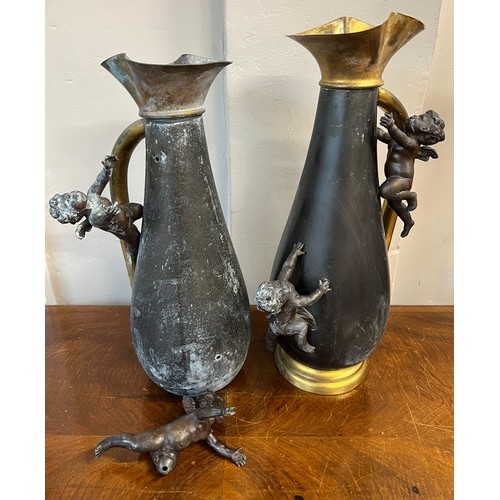 1189 - A pair of brass and spelter vases with cherub decoration. 40cm h.