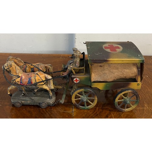 1097 - A WW1 tin plate ambulance pulled by two horses on a wooden base with a soldier plus an unassociated ... 