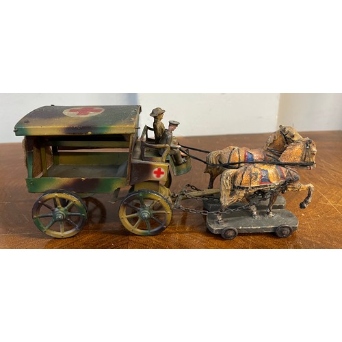 1097 - A WW1 tin plate ambulance pulled by two horses on a wooden base with a soldier plus an unassociated ... 