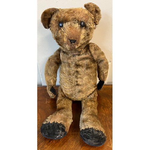 1098 - An early 20thC mohair teddy bear with black button eyes together with knitted trousers, jacket and h... 