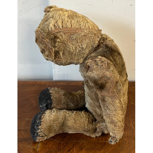 1098 - An early 20thC mohair teddy bear with black button eyes together with knitted trousers, jacket and h... 