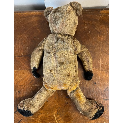 1098 - An early 20thC mohair teddy bear with black button eyes together with knitted trousers, jacket and h... 