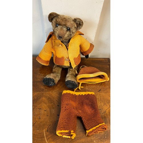 1098 - An early 20thC mohair teddy bear with black button eyes together with knitted trousers, jacket and h... 