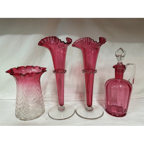 320 - A quantity of cranberry glass to include a pair of fluted vases  27cm h, a fluted vase 16.5cm h, a d... 