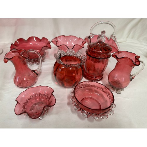 320 - A quantity of cranberry glass to include a pair of fluted vases  27cm h, a fluted vase 16.5cm h, a d... 