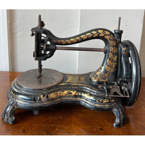 1299 - A Jones cat back hand sewing machine in case.