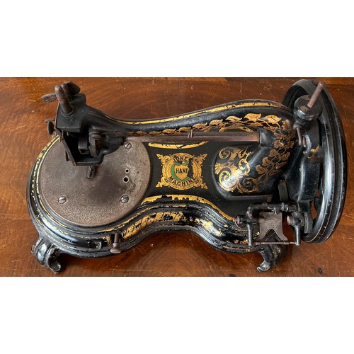 1299 - A Jones cat back hand sewing machine in case.