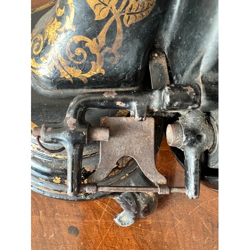 1299 - A Jones cat back hand sewing machine in case.