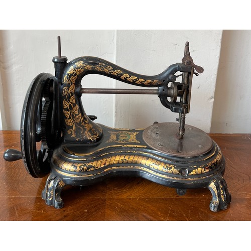 1299 - A Jones cat back hand sewing machine in case.