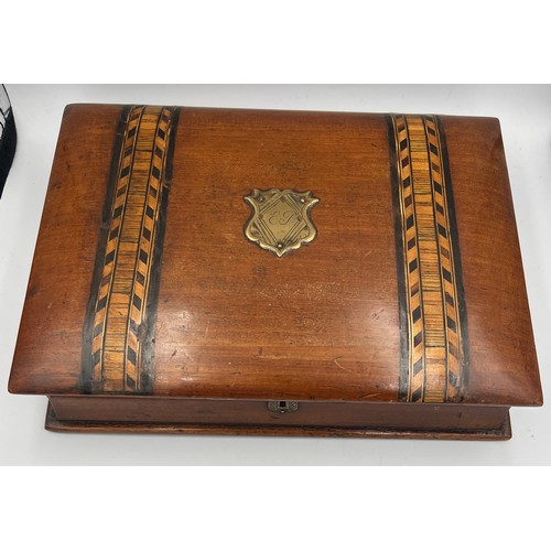 1175 - A 19thC mahogany book shaped writing/stationary box inlaid with Tunbridge ware bands. 26cm x 19cm x ... 