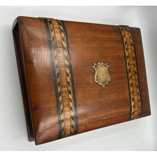 1175 - A 19thC mahogany book shaped writing/stationary box inlaid with Tunbridge ware bands. 26cm x 19cm x ... 