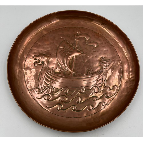 1179 - Keswick school copper wall plate by W.H Mawson embossed with a Viking ship, 20.5cm d,