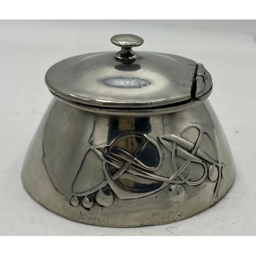 1185 - Archibald Knox Tudric polished pewter inkwell. 10cm x 10cm.