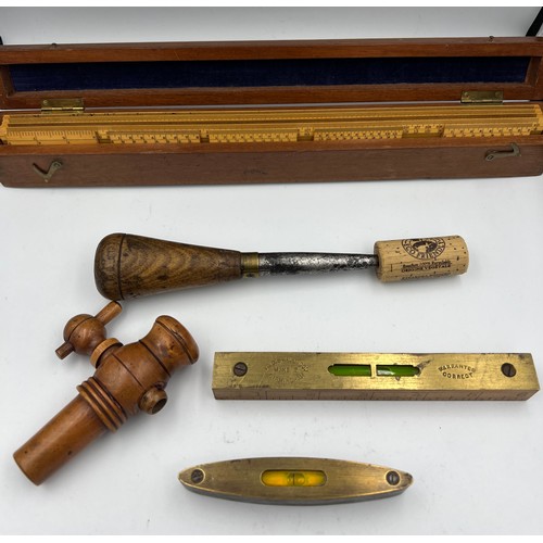 1309 - Two small wooden cased spirit levels, a boxwood spigot, a treen, brass and metal fid and a boxed set... 