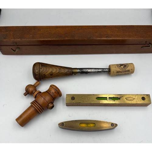 1309 - Two small wooden cased spirit levels, a boxwood spigot, a treen, brass and metal fid and a boxed set... 