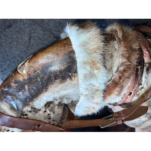 1102 - An early 20thC skin covered wooden rocking horse with leather saddle and bridle. Horse hair tail. 11... 