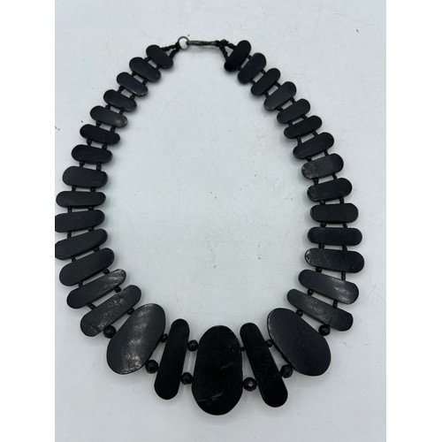 390 - A Victorian jet collar style necklace. Largest bead 4cm x 2.5cm.