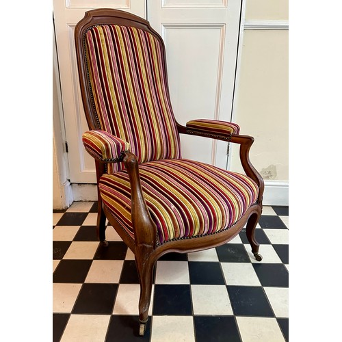 32 - A French mahogany high back armchair with upholstered seat, back and arms, front cabriole legs and c... 